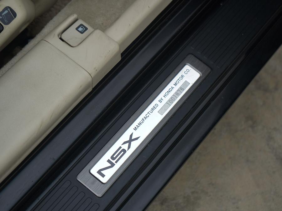 Close-up of a Honda NSX door sill plate reading NSX, manufactured by Honda Motor Co.