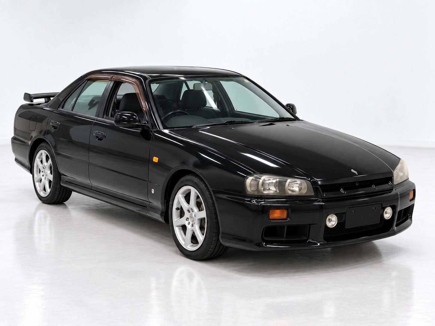 Black Nissan Skyline R34 ER34 sedan front three-quarter view