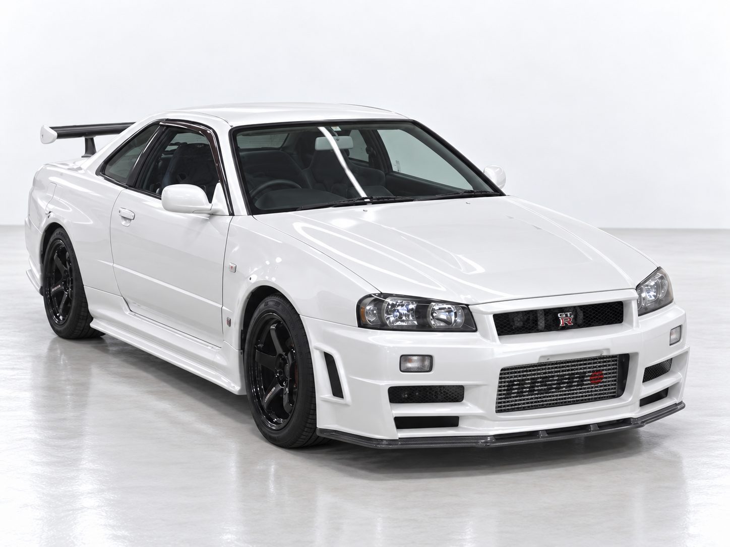 White Nissan Skyline R34 GT-R BNR34 front three-quarter view