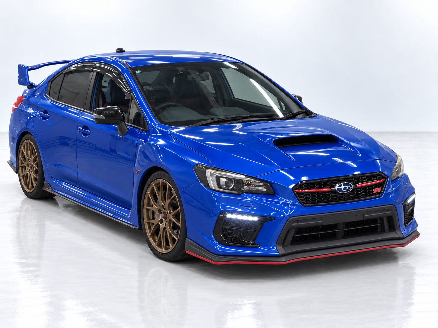 Blue Subaru WRX STI VAB Final Edition with bronze wheels, front three-quarter studio shot