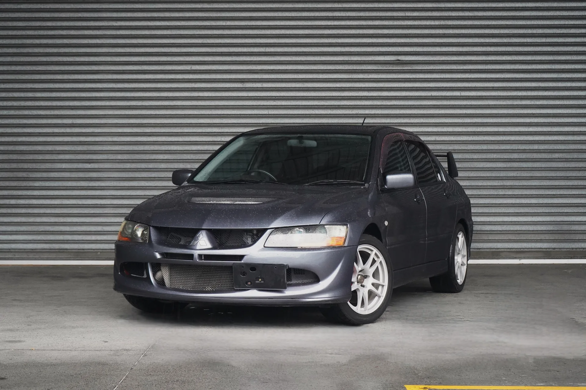 A second Mitsubishi Lancer Evolution VIII imported by Fukasawa Car Imports, grey, with factory Recaro seats