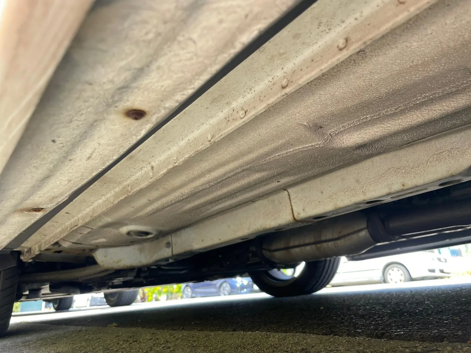 Underbody detail of an imported Evolution VIII GSR showing rust-preventative coating
